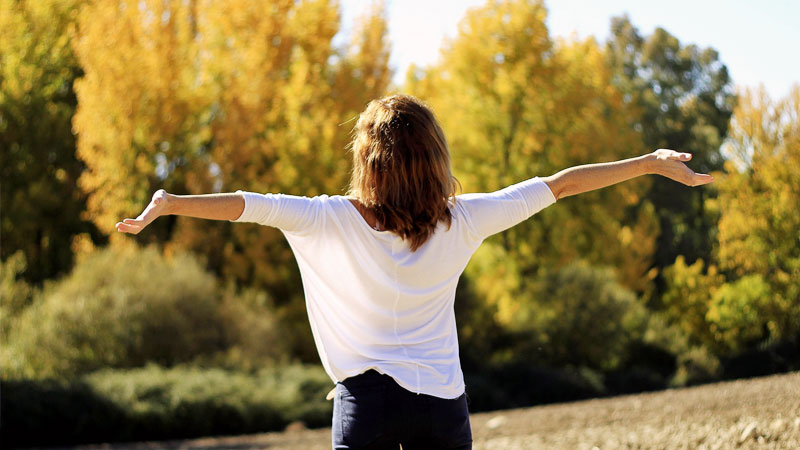 Woman Doing Mindfulness Exercises Outdoors with Trees